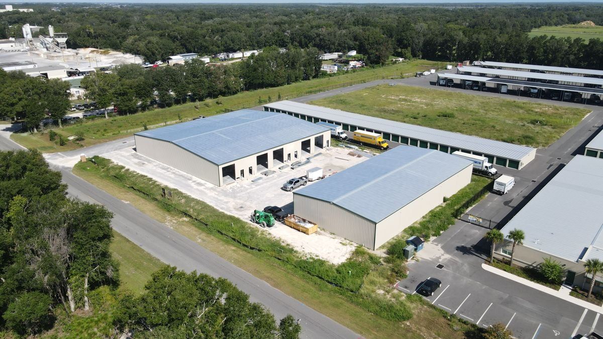 Aerial view of flex buildings in Rogers Industrial Park, Leesburg, Florida, surrounded by trees.